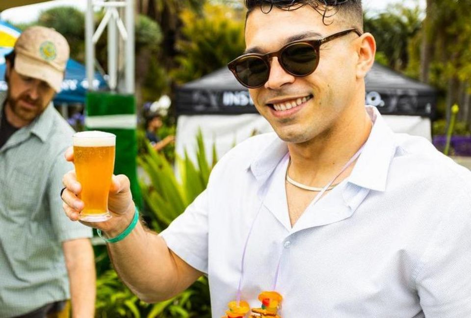 man wearing sunglasses holding a beer