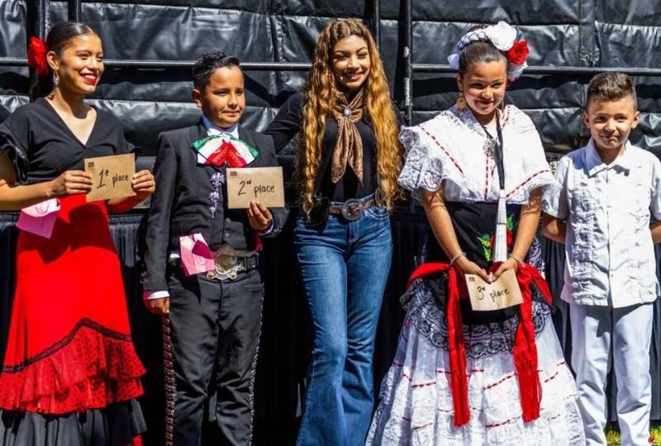 young people smiling and holding cards