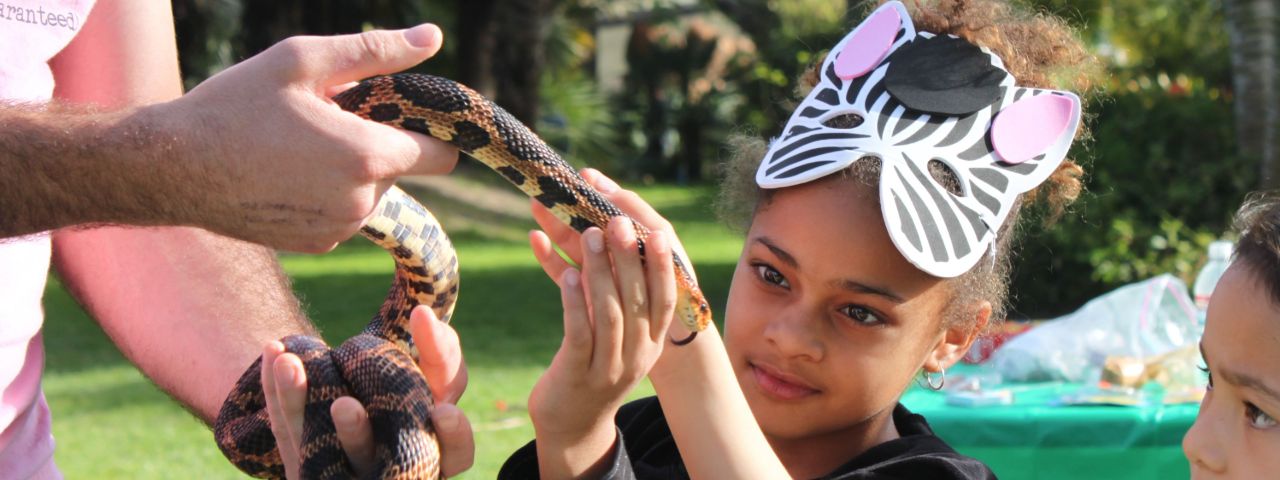 girls petting snake