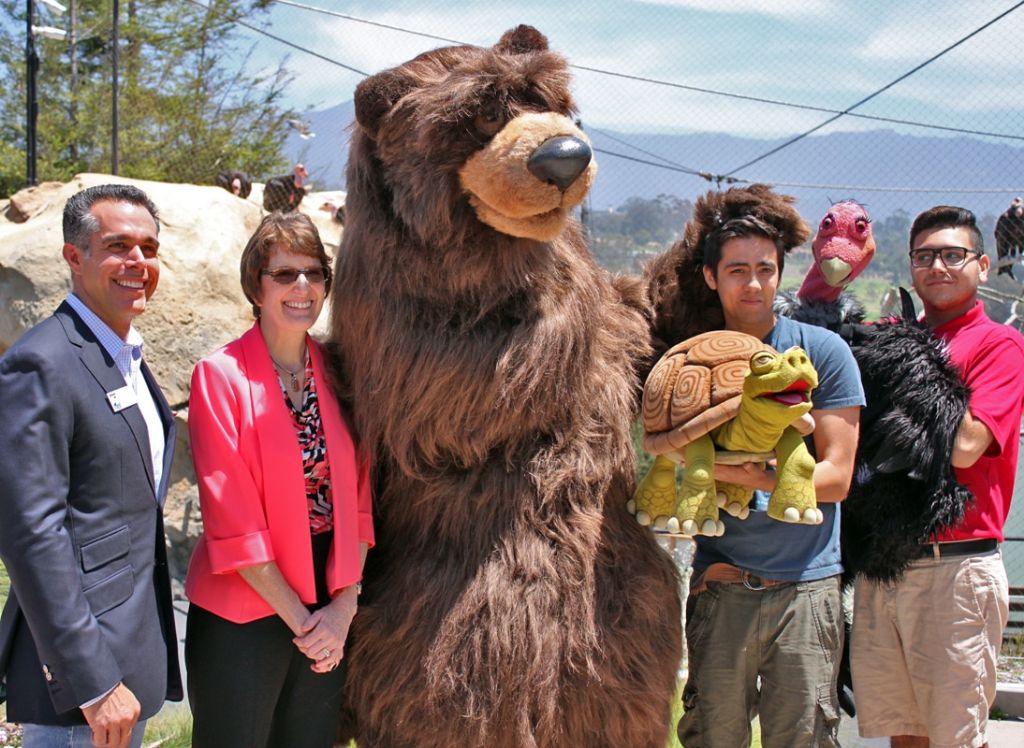 people posing with mascot animals